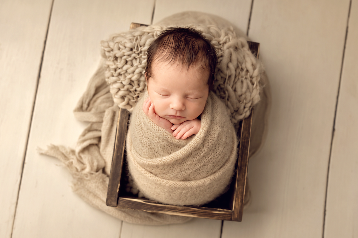 Newborn photography blanket styled in a soft neutral studio setup